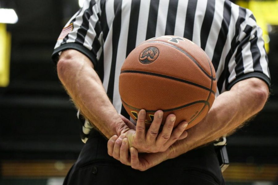 An official holds the ball before tip-off. (Collegian file photo)