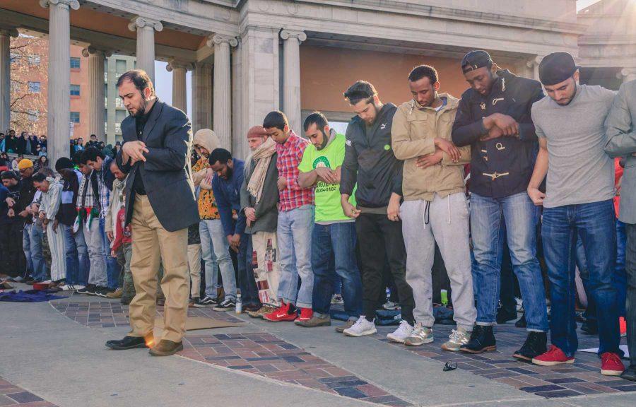 The Muslims in attendence of Denver's Muslim and immigrant solidarity event take a moment for their afternoon prayer before the speakers resumed (Davis Bonner | Collegian)