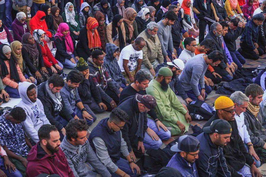 The Muslims in attendance of Denver's Muslim and immigrant solidarity event take a moment for their afternoon prayer before the speakers resumed (Davis Bonner | Collegian)
