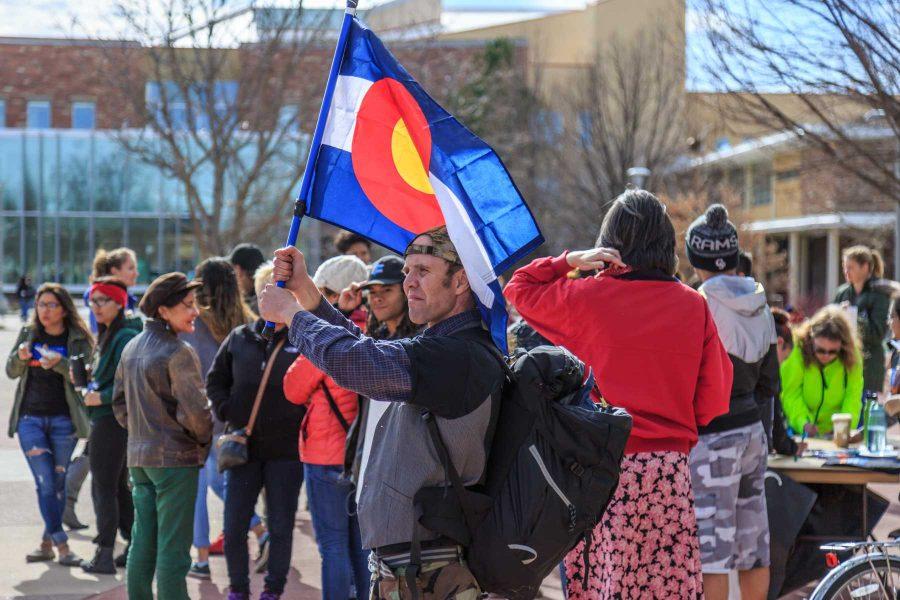 Jake Knebel, an activist with Fort Collins for Progress, stands with his Colorado flag during the "To Immigrants With Love" event on the plaza. February 8, 2017 (Davis Bonner | Collegian)