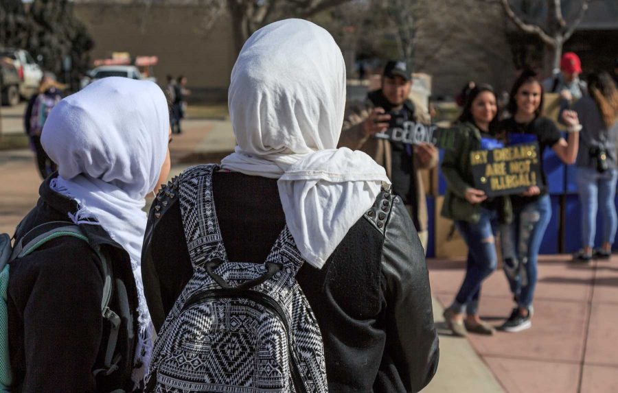 Two Muslim students watch as others take pictures with College Republicans at CSU's 'Free Speech Wall' during the "To Immigrants With Love" event on the plaza hosted by Dreamers United. February 8, 2017 (Davis Bonner | Collegian)