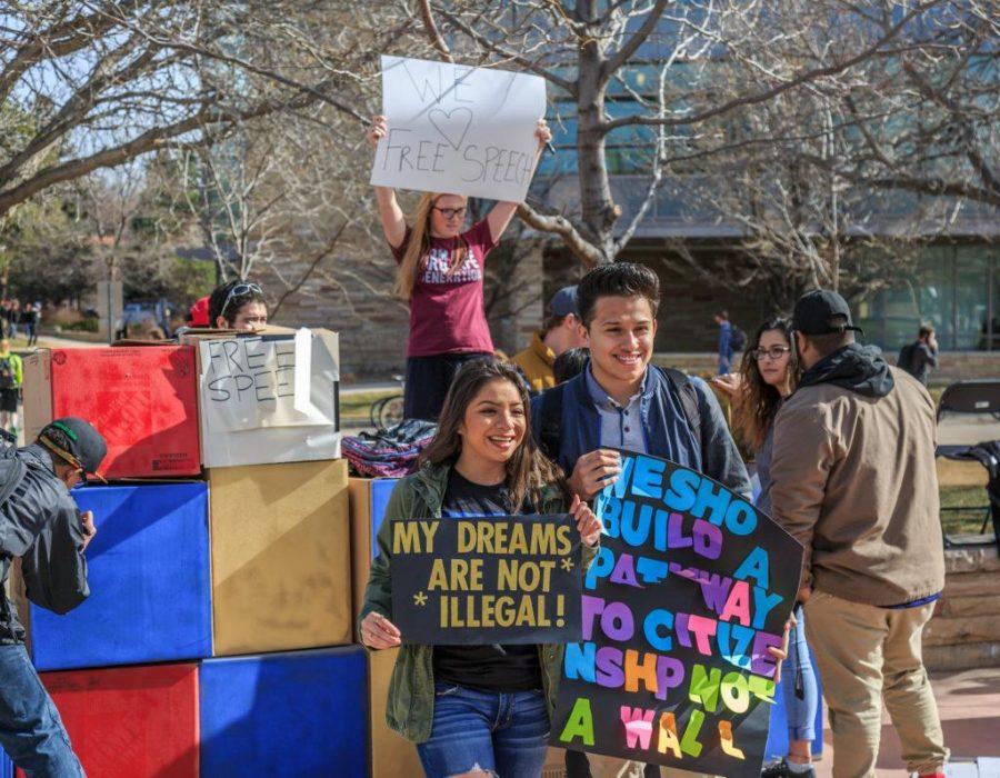 Frida Mugica is joined by her friends as they take pictures with College Republicans at CSUs Free Speech Wall during the To Immigrants With Love event on the plaza. February 8, 2017. Behind them, Emily Faulkner holds up a sign saying We 