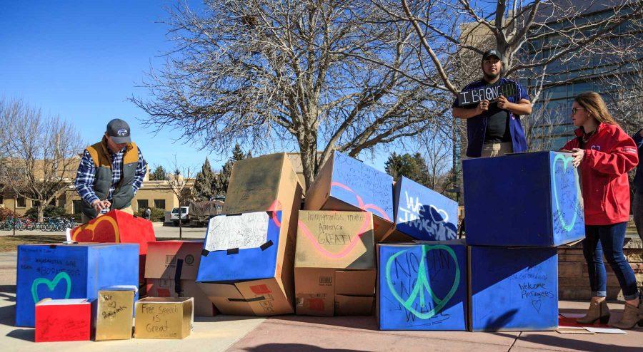 College Republicans at CSU rebuild their 'Free Speech Wall' after being knocked over by strong winds during the "To Immigrants With Love" event on the plaza. February 8, 2017 (Davis Bonner | Collegian)