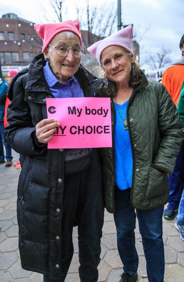 Renate Justin (right) stands with roughly 1,200 others showing solidarity with Planned Parenthood in Old Town Square. This event was organized by FoCo Local Girl Gang (Davis Bonner | Collegian)