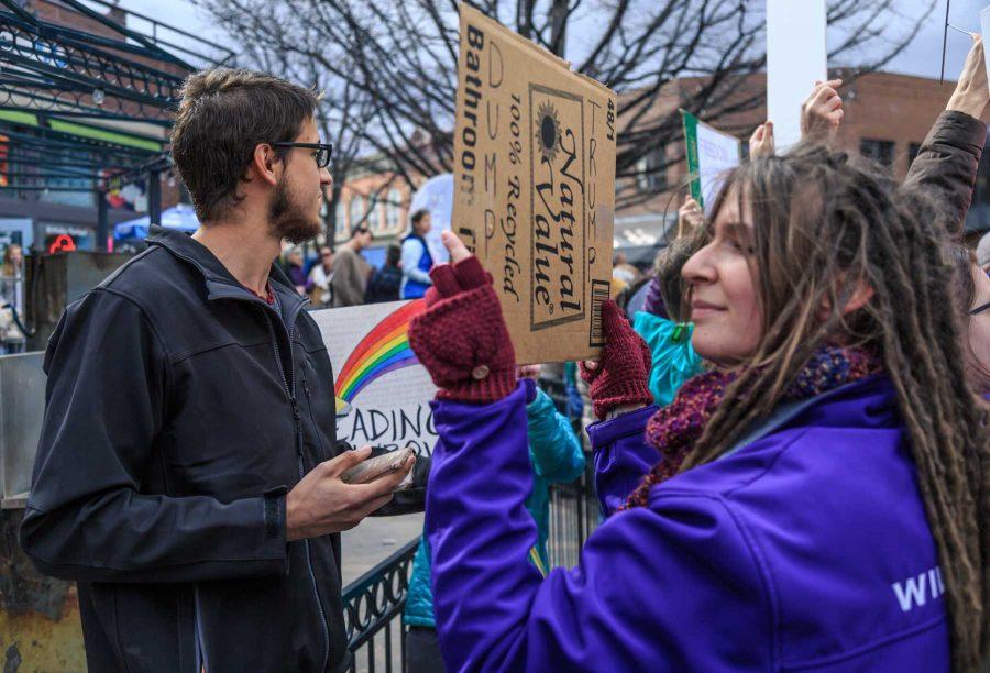 Jared recites passages from the Bible and engages rally participants in theological conversation during FoCo Local Girl Gang's Planned Parenthood solidarity rally. (Davis Bonner | Collegian)
