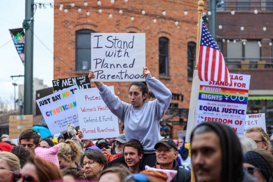 Samantha Patrick sits above the roughly 1,200 strong crowd that turned out for FoCo Local Girl Gang's Planned Parenthood solidarity rally (Davis Bonner | Collegian)