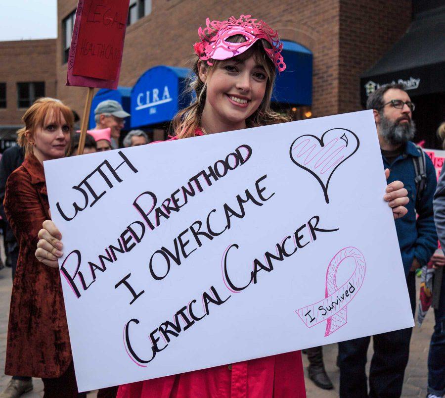 Erin stands with her sign in support of Planned Parenthood. She is joined by roughly 1,200 others at FoCo Local Girl Gang's Planned Parenthood solidarity event in Old Town Square(Davis Bonner | Collegian)