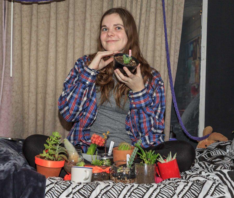 Kate Border, a freshman art major with a concentration in painting sits with her 29 succulents, a collection she grew from just a handful at the beginning of the semester. Kate is also a member of the horticulture club, one of the sources of her large plant collection (Davis Bonner | Collegian)