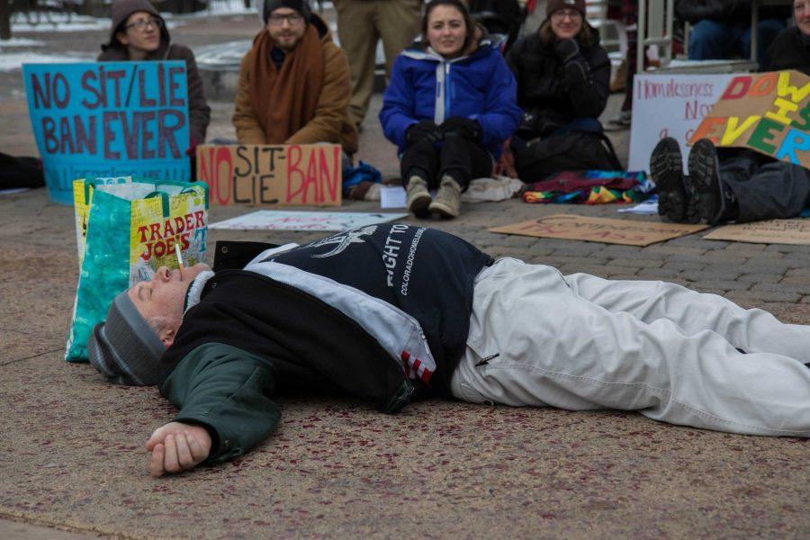 Jeff McKissack makes snow angels in the concrete after proclaiming Im not standing for this anymore at the Sit- Lie Ban on Friday afternoon (Julia Trowbridge | Collegian)