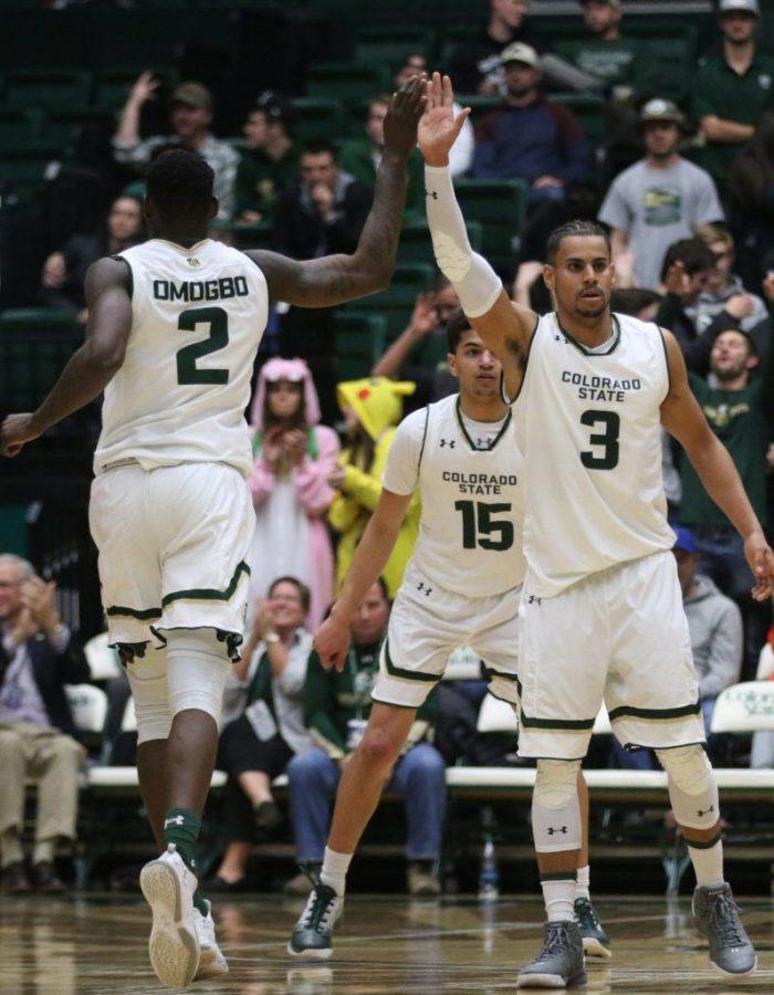 Seniors Emmanuel Omogbo and Gian Clavell give each other a high five after a big play for the Rams during the second half of action against Utah State on February 7, 2017. (Elliott Jerge | Collegian)