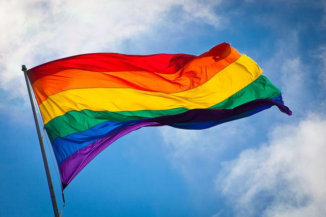 The rainbow flag, a symbol of LGBTQ pride, waving in the wind