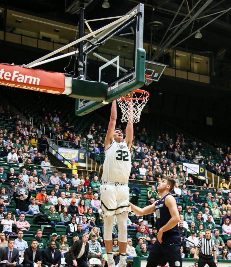 Nico Carvacho dunks against Utah State defender Quinn Taylor helping the team to a 69-52 win Feb. 7 (Davis Bonner | Collegian)