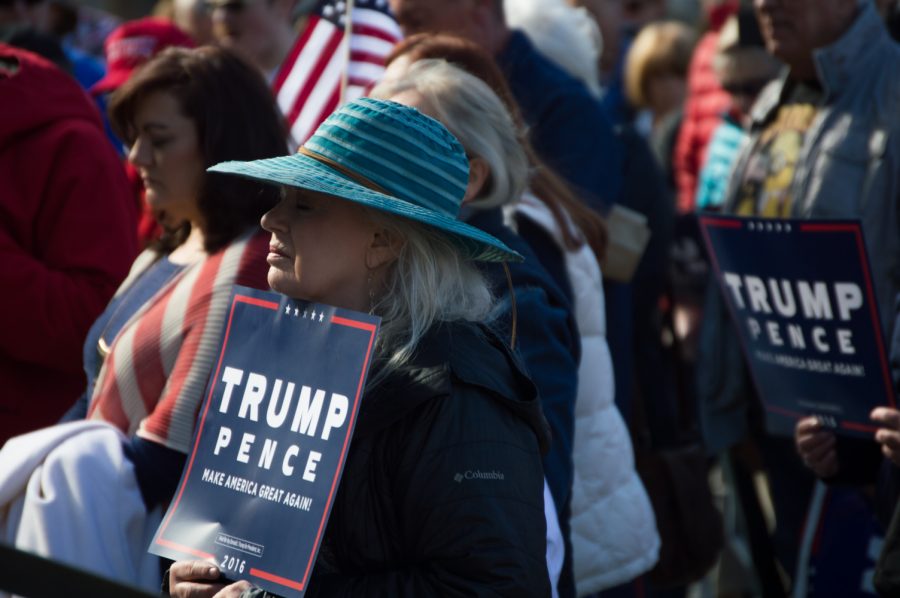 Supporters bow their head in a prayer led by Father Andre at the Trump Rally in Denver Saturday. Photo by Kaitlyn Ancell | Collegian