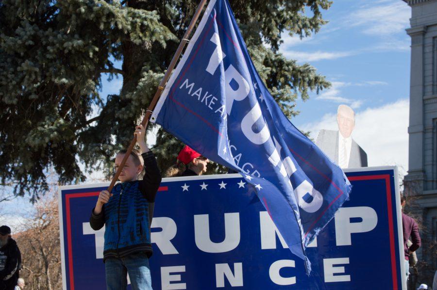 Brycen Thomas, age 9, waves a Trump flag at the March 4 Trump Rally in Denver on Saturday. Photo by Kaitlyn Ancell | Collegian