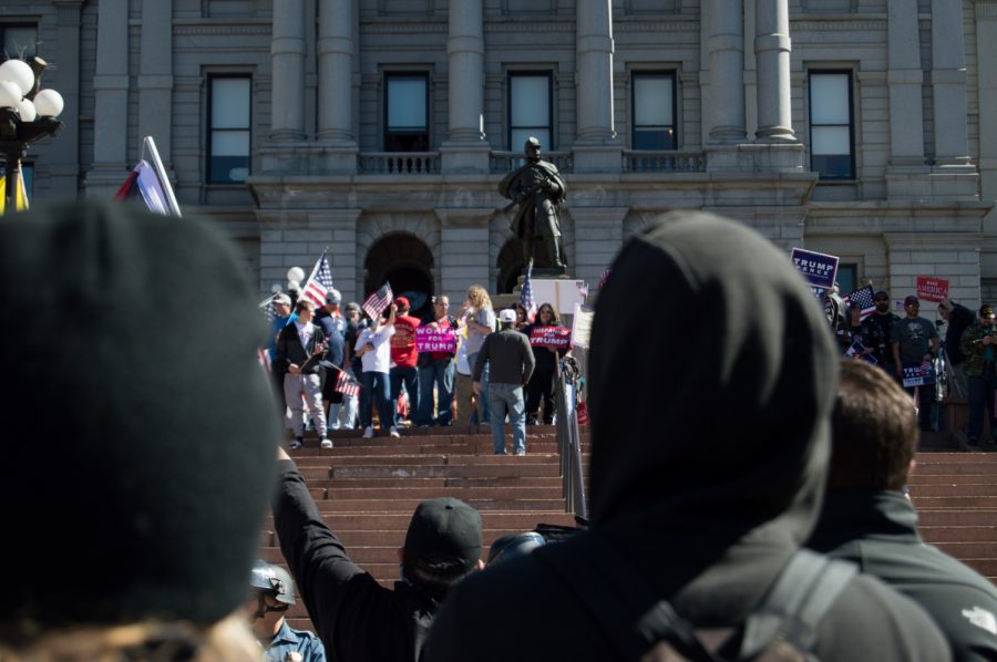 A clear divide was present at the March 4 Trump rally in Denver SAturday between Trump supporters and the ANTIFA protestors. Photo by Kaitlyn Ancell | Collegian