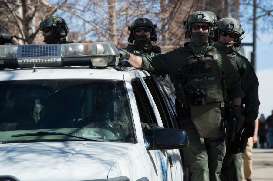 Back up Denver Police officers stand by at the March 4 Trump rally in Denver on Saturday. Photo by Kaitlyn Ancell | Collegian