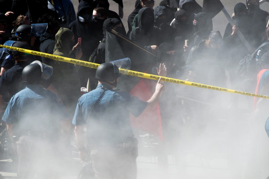Cops utilize a smoke bomb against the ANTIFA protestors to keep the situation peaceful at the March 4 Trump rally in Denver on Saturday. Photo by Kaitlyn Ancell | Collegian