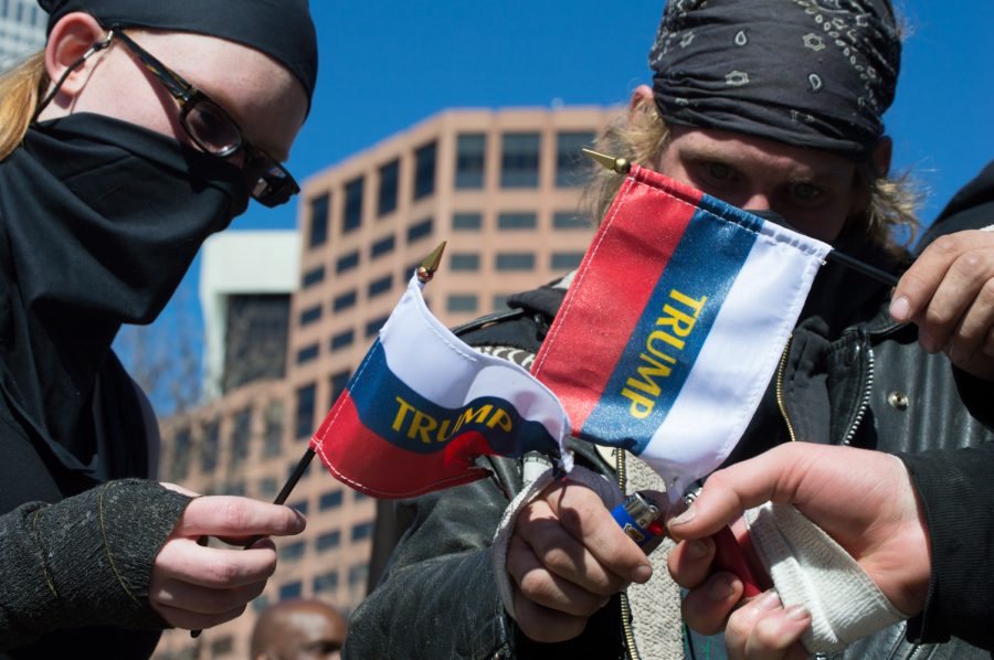 An ANTIFA protestor burns a Trump flag in demonstration at the March 4 Trump rally in Denver on Saturday. Photo by Kaitlyn Ancell | Collegian