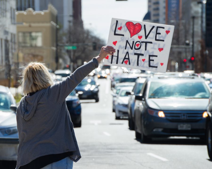 Stefanie Thomas holds a sign by the street of the State Capitol building in Denver at the March 4 Trump rally on Saturday. Photo by Kaitlyn Ancell | Collegian