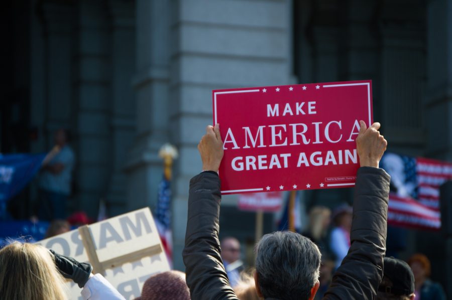 Trump supporters decked out the front of the State Capitol building in patriotic clothing, signs, and American Flags. Trump Rally Denver State Capitol. Photo by Kaitlyn Ancell | Collegian