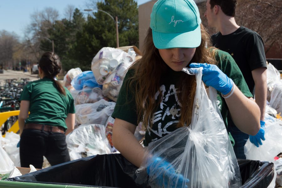 Cienna Semsak sorts through a plastic bag of garbage for the Food Waste Audit on the plaza Wednesday morning. Photo by Kaitlyn Ancell | Collegian