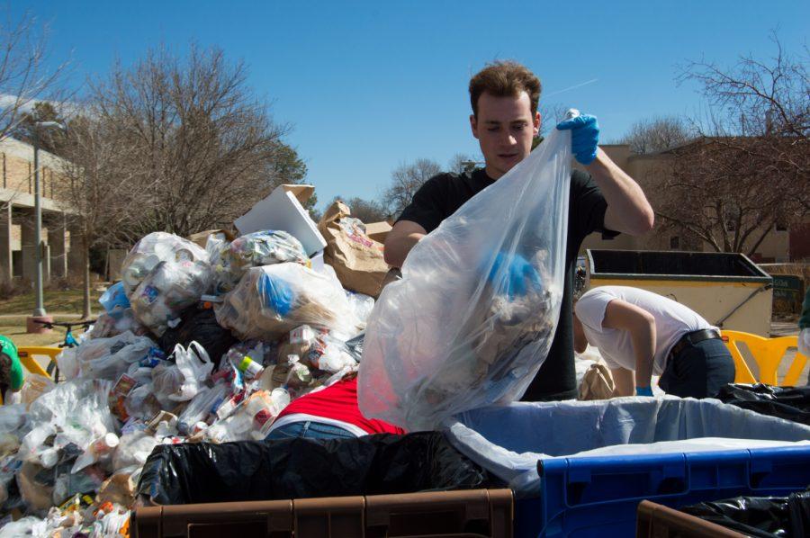 Drew Bell participates in the Food Waste Audit on the plaza Wednesday morning, led by the Eco Leaders organization. Photo by Kaitlyn Ancell | Collegian