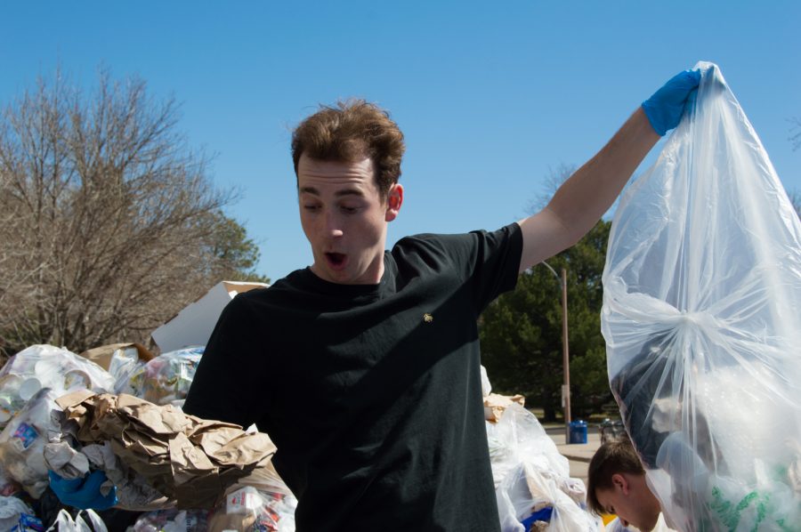 Drew Bell was shocked at some things found in the trash while participating in the Food Waste Audit on the plaza Wednesday morning. Photo by Kaitlyn Ancell | Collegian