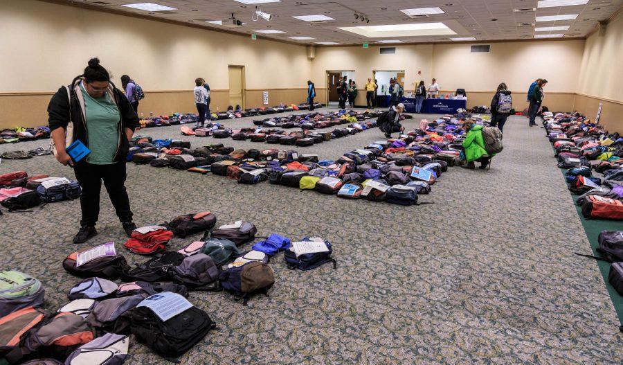 Students read letters telling the stories of those who have committed suicide while in college. Brought to CSU by Active Minds, CSU Health Network and ASCSU, Send Silence Packing is a traveling exhibit that addresses student suicide during its tour of colleges around the US. Visitors are invited to walk among the roughly 1,100 backpacks representing student suicides in the US every year. (Davis Bonner | Collegian)