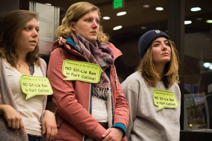 Madison Tolan, a senior at CSU studying Biomedical Sciences, Alide Berndzen, a post graudate from Berlin, and Haley Dallas, a junior at CSU studying Natural Resource Management show their opposition to the Sit- Lie Ban at the city council meeting on Tuesday, March 3 (Julia Trowbridge | Collegian)