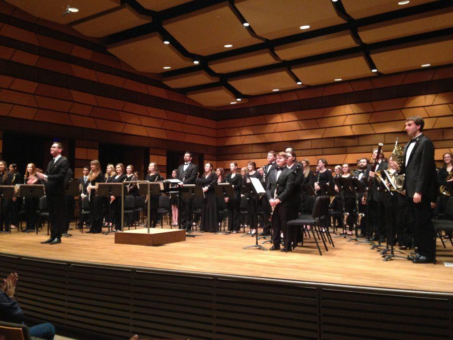 The CSU Concert Band stands after their final piece in Joie de Vivre, a French-inspired repertoire to kick off their Spring 2017 performance season. Photo credit: Mckenzie Moore