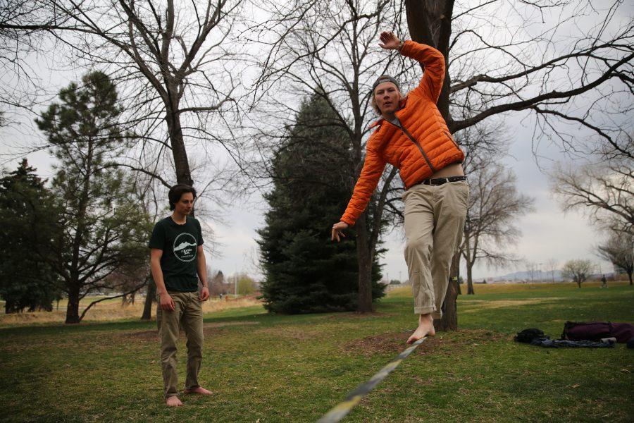 Colorado State University student Peter Kubly, seeking a Communications degree, practices his slacklining skills on Tuesday afternoon near Laurel Street while Daniel Chavez looks on. (Forrest Czarnecki | Collegian)