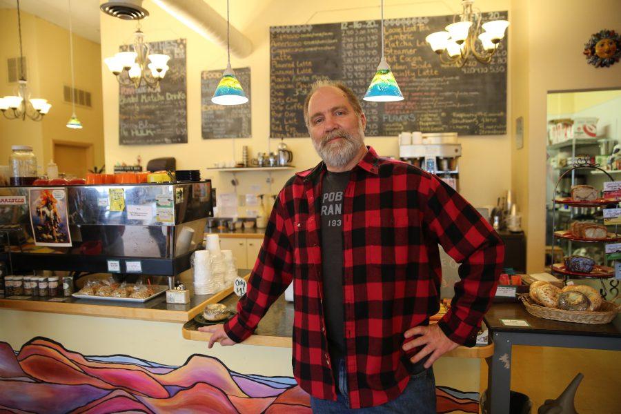 Colin Gerety, the owner of Momo Lolo Coffee House, poses for a portrait at the coffee house on Tuesday afternoon. Some of the businesses along Elizabeth Street have been affected by the construction happening at the intersection of Shields and and Elizabeth Streets. (Forrest Czarnecki | Collegian)