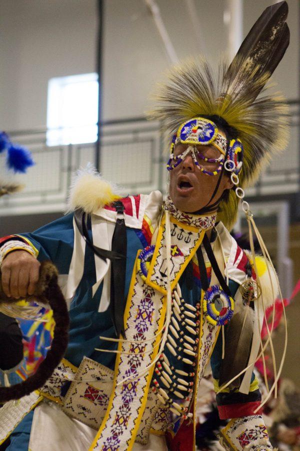 A dancer sings along with the drum group  at the 25th Annual NCIPA Powwow. (Ashley Potts | Collegian)