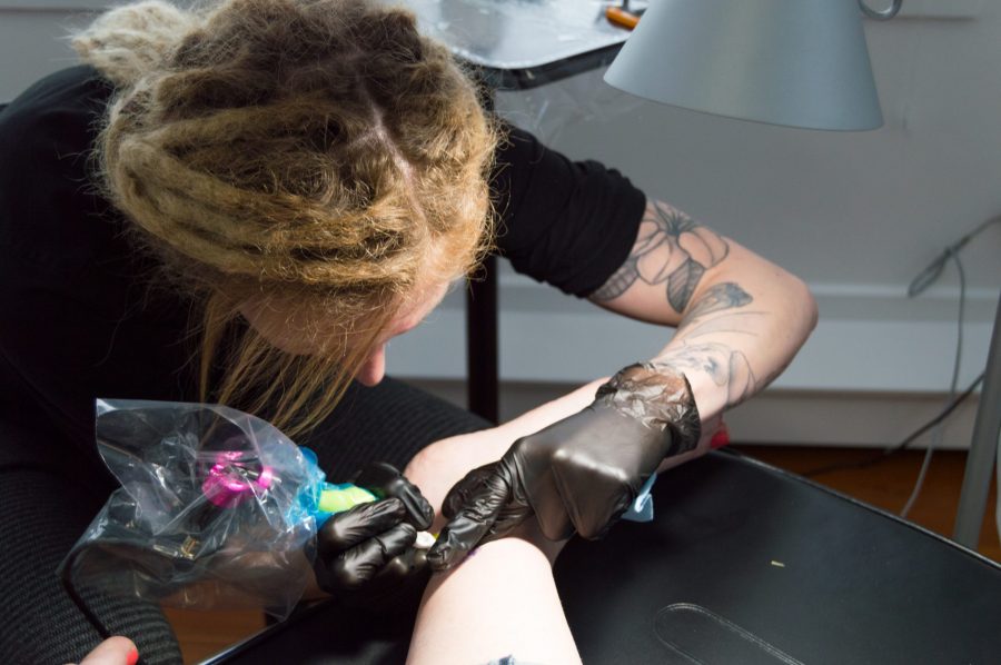 CSU alumni Audrey Ancell tattoos a client in her new private studio, Modern Medium Tattoo Studio, located on 311 E. Mulberry Street.  Photo by Olive Ancell | Collegian