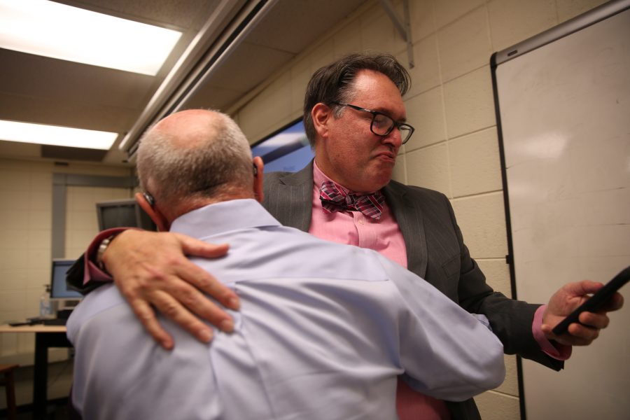 Kevin Hall, facing, shares an embrace with colleague Rob Reuteman after hearing the announcement that an investigative reporting team Hall was on won the 2017 Pulitzer Prize for Explanatory Reporting on the "Panama Papers". (Forrest Czarnecki | Collegian)