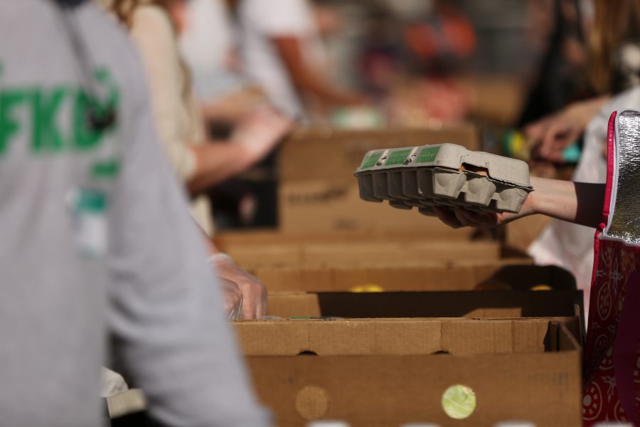 People take a carton of eggs at an event organized by SLiCE and the Larimer County Food Bank on Thursday afternoon in front of the Sherwood Forest. The event was put on to help fight food insecurity at Colorado State University. (Forrest Czarnecki | Collegian)