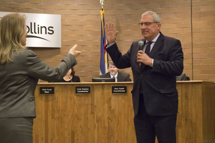 Mayor Wade Troxell (right) was re-elected Tuesday night during the City Hall Council meeting. 
