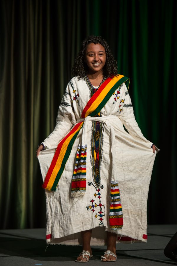 A representative from Ethiopia displays their cultural dress during the Council of International Student Affairs organized fashion show. (Davis Bonner | Collegian)