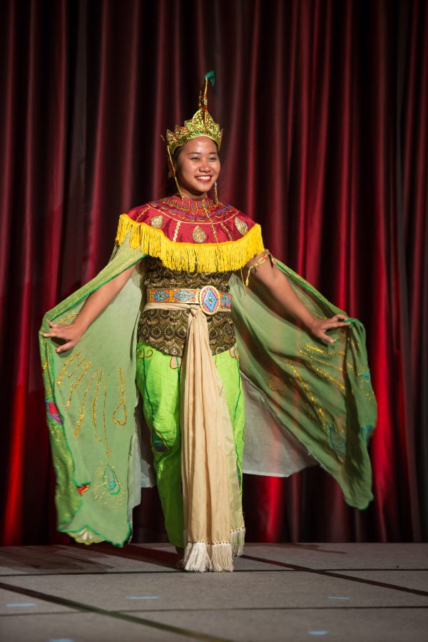 A representative from Indonesia displays their cultural dress during the Council of International Student Affairs organized fashion show. (Davis Bonner | Collegian)