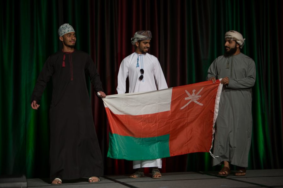 Representatives from Oman display their countries flag during the Council of International Student Affairs organized fashion show. (Davis Bonner | Collegian)