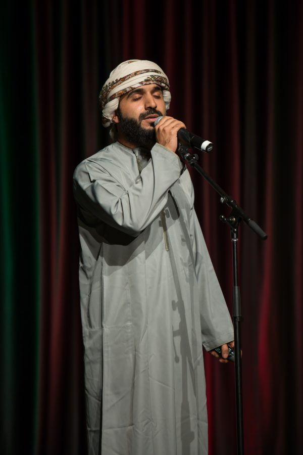 A representative from Oman performs a hymn during the Council of International Student Affairs organized fashion show. (Davis Bonner | Collegian)