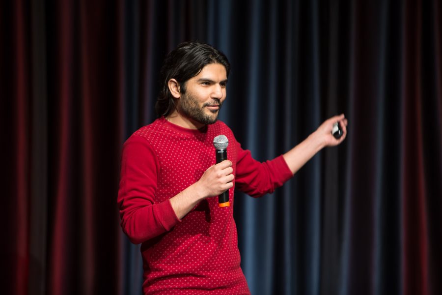 A representative from Turkey shows a video highlighting their country during the Council of International Student Affairs organized fashion show. (Davis Bonner | Collegian)