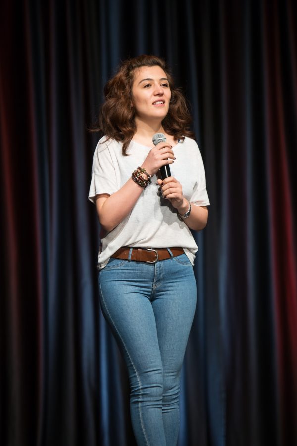 A representative from Turkey shows a video highlighting their country during the Council of International Student Affairs organized fashion show. (Davis Bonner | Collegian)