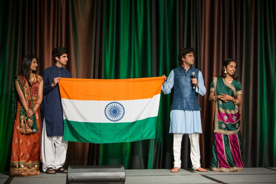 Representatives from India display their countries flag during the Council of International Student Affairs organized fashion show. (Davis Bonner | Collegian)