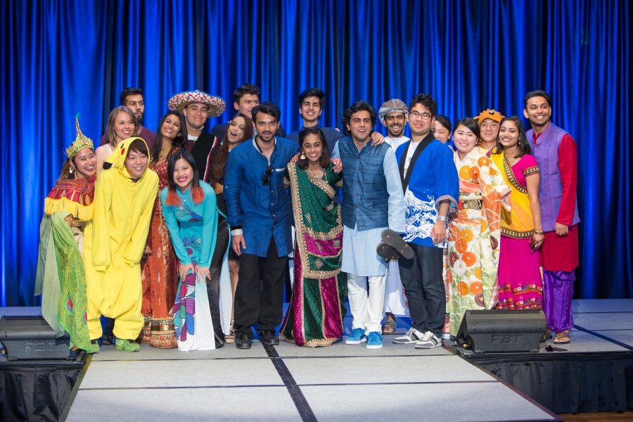 All the representatives from the  International Student Affairs organized fashion show gather on stage after the event. (Davis Bonner | Collegian)