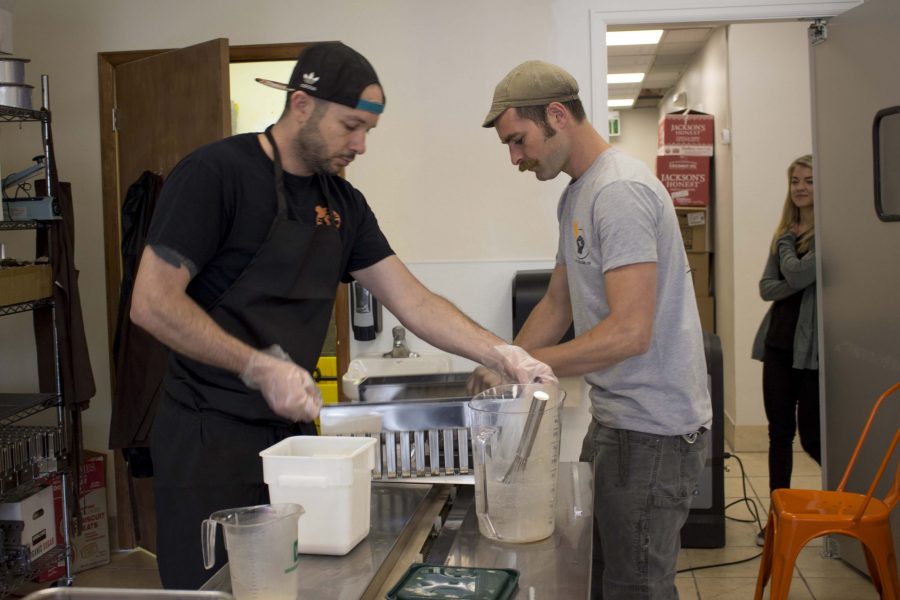 Co-owners Jarod Dunn (left) and Sam Edwards-Jenks (right) make popcicles for Revolution Artisan Pops from inside the new Revolution Market in Old Town. (Brooke Buchan l Collegian) Photo credit: Brooke Buchan
