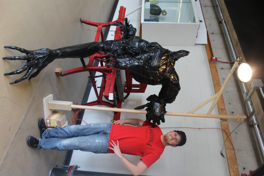 Art major Conner Hollen shows off a piece that he made for his Sculpture I class. Photo credit CJ Johnson.