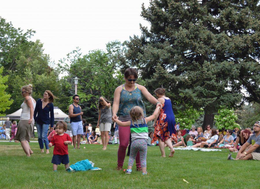 People of the crowd dance together at the Lagoon Summer Concert Series: Tatanka performance. Photo by Olive Ancell | Collegian