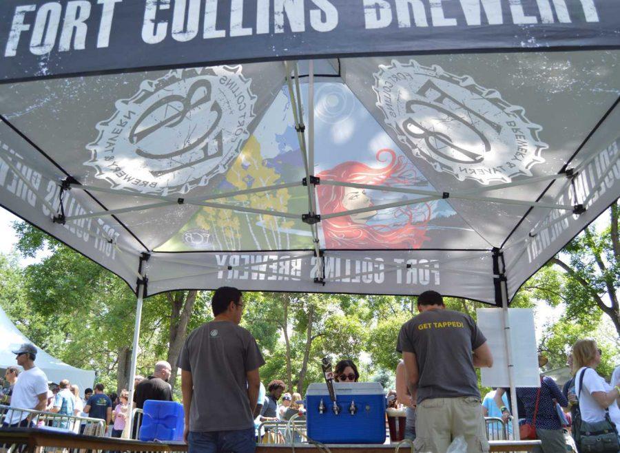 Fort Collins Brewery's tent featured colorful graphics and employees with funny shirts at the Colorado Brewers' Festival. Photo by Olive Ancell | Collegian