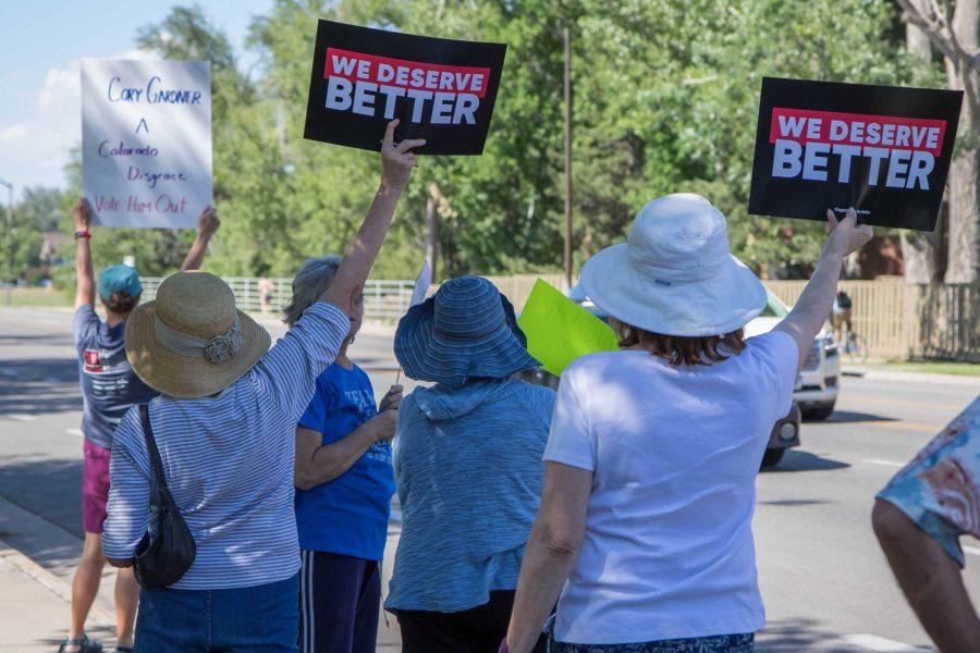 Protesters lined Shields Street outside of Senator Gardner's office with signs like 'We Deserve Better' to make a point against the new health care bill (Julia Trowbridge | Collegian)